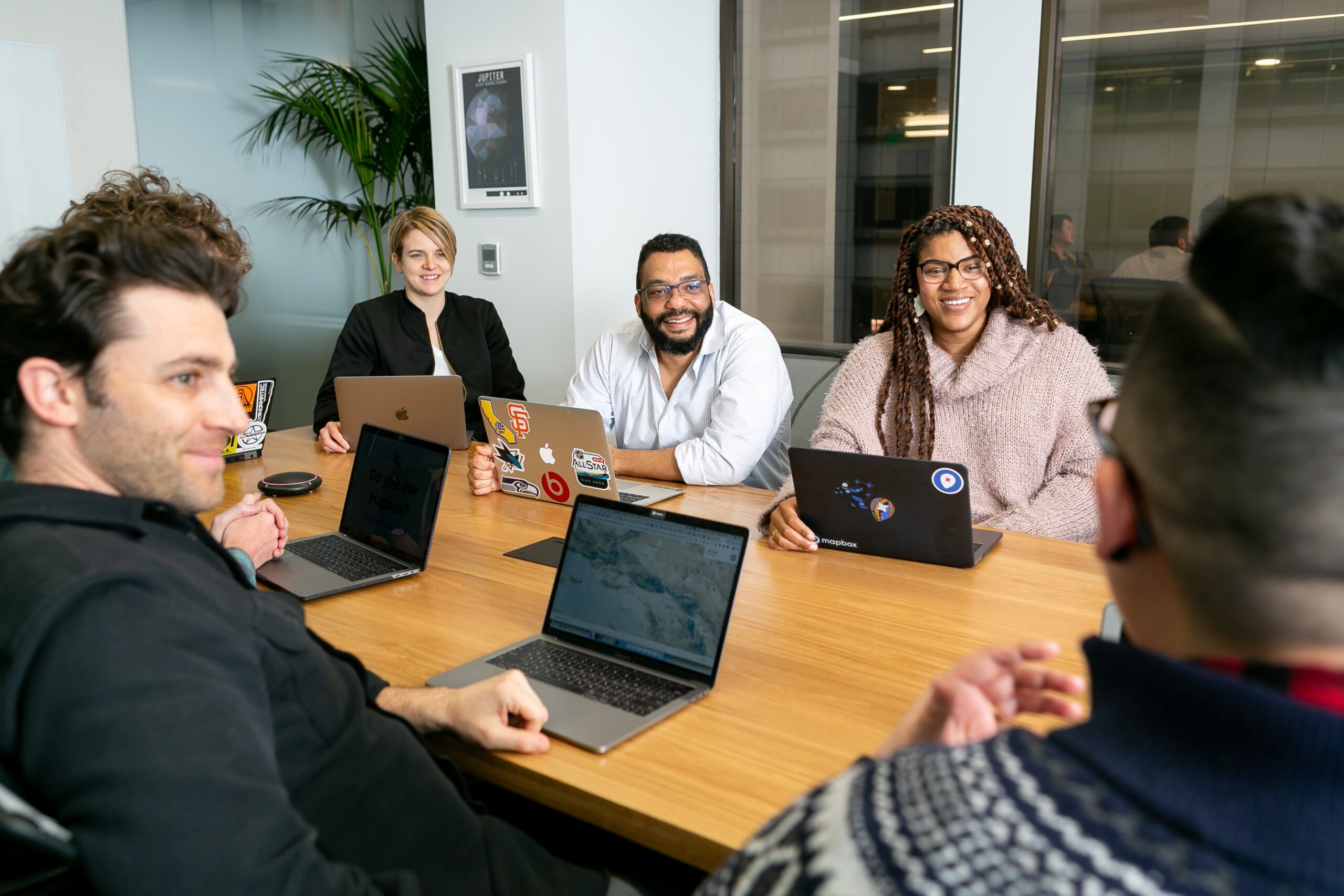 Men and women at a meeting around a conference table